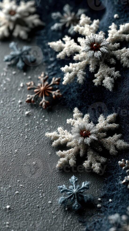 Snowflakes arranged on a textured surface with a dark blue background creating a winter-themed display near the holiday season photo