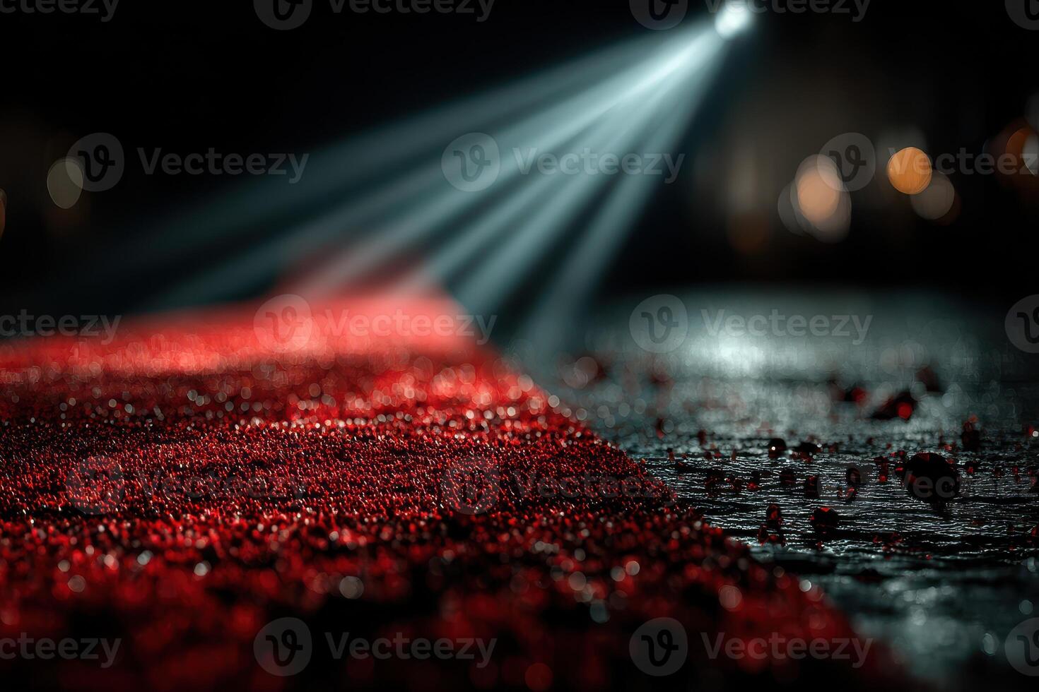 Red carpet event taking place in a dimly lit venue with focused beam of light illuminating the glamorous setting photo