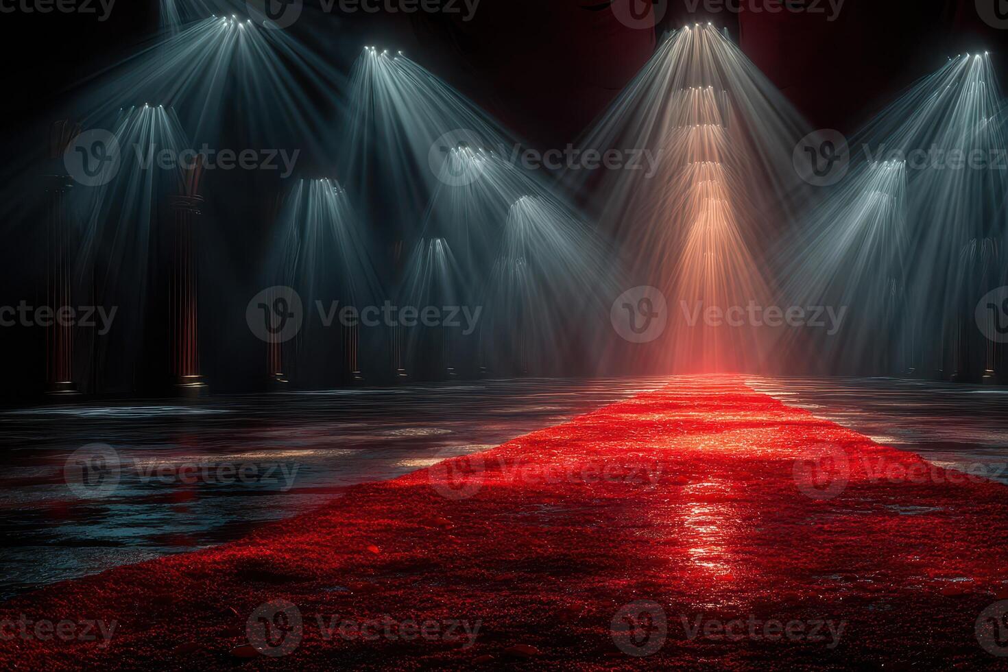 Stage illuminated with dramatic lighting effects highlighting a red carpet in a dark hall during a special event photo