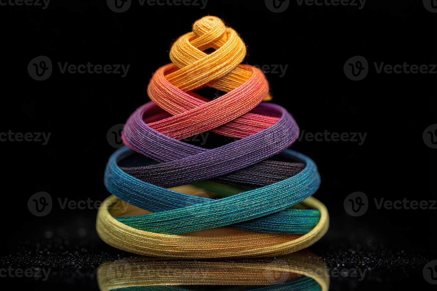 Colorful spiral arrangement of ribbons on a black background showcasing artistic creativity and design photo