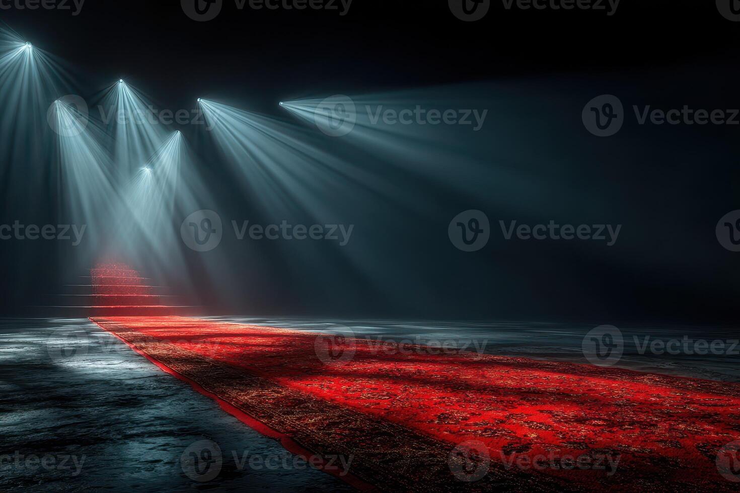 Bright lights illuminate a red carpet leading to a mysterious staircase in a darkened space during an evening event photo