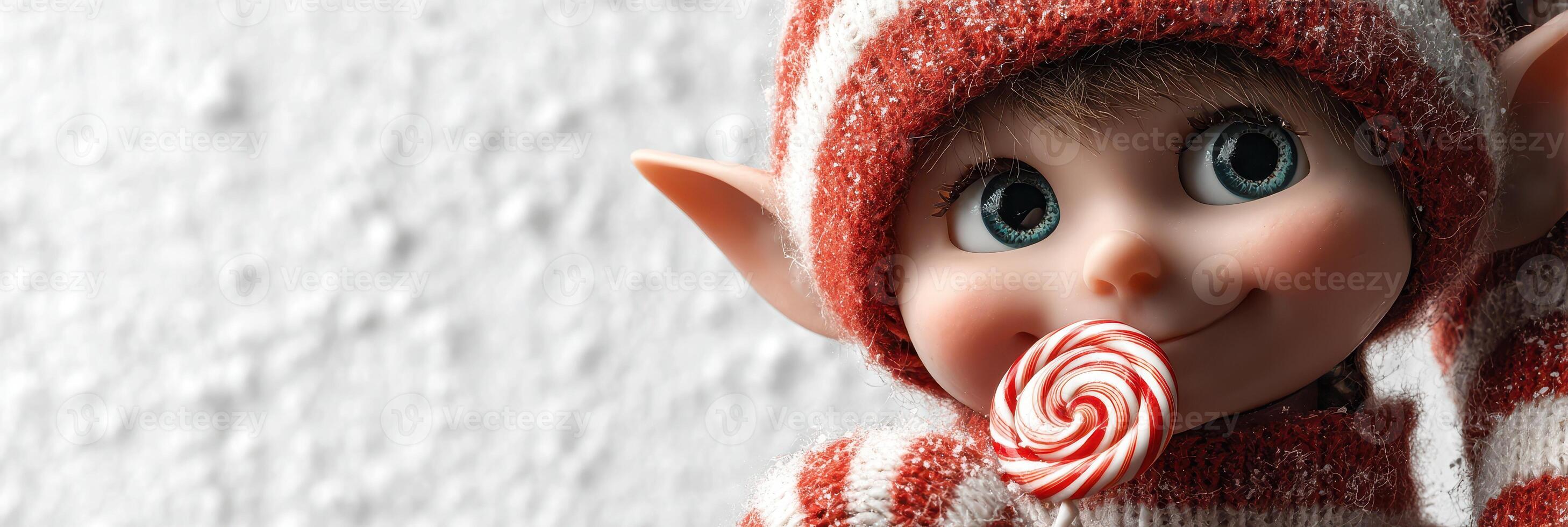 Cheerful elf character holding a striped candy in a festive setting during winter photo