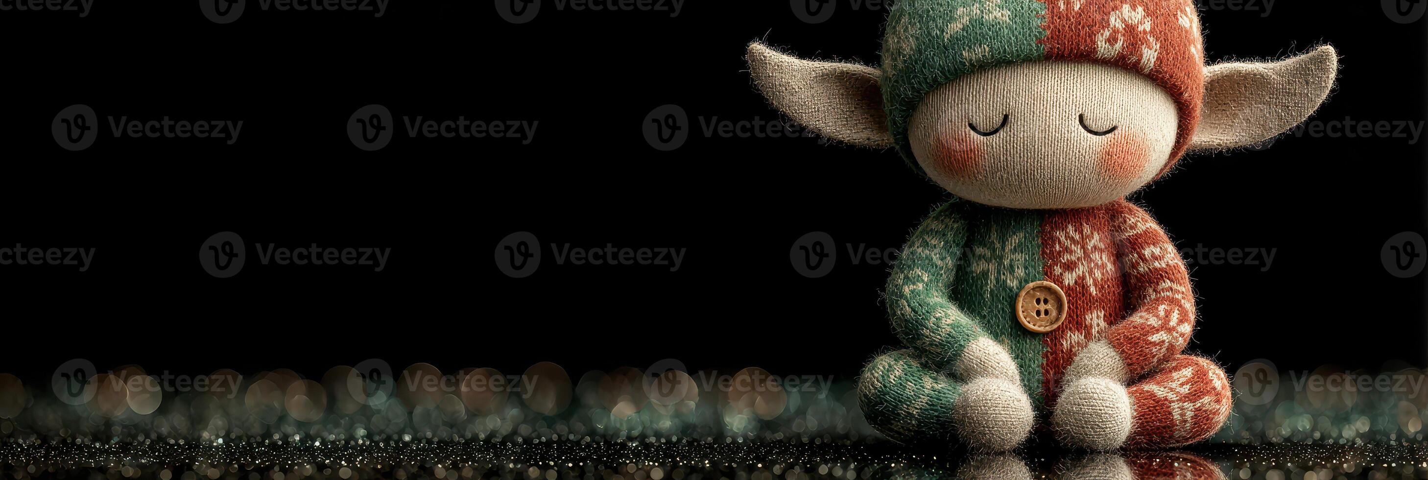 Festive elf figurine wearing knitted attire peacefully resting on reflective surface photo