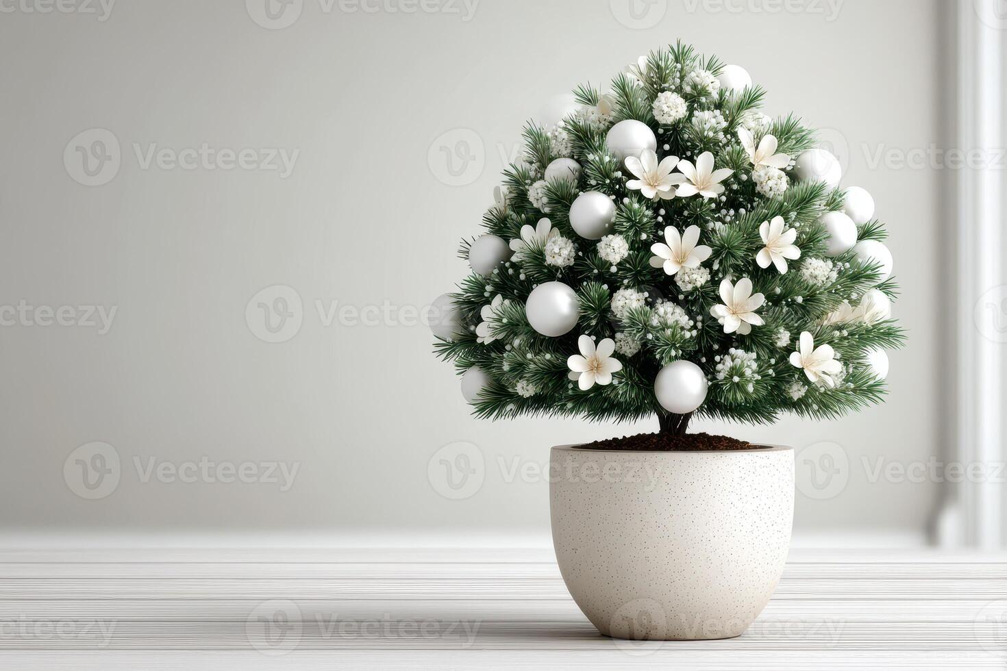 Decorative mini Christmas tree with white ornaments and flowers in a simple pot for holiday decoration in a modern setting photo