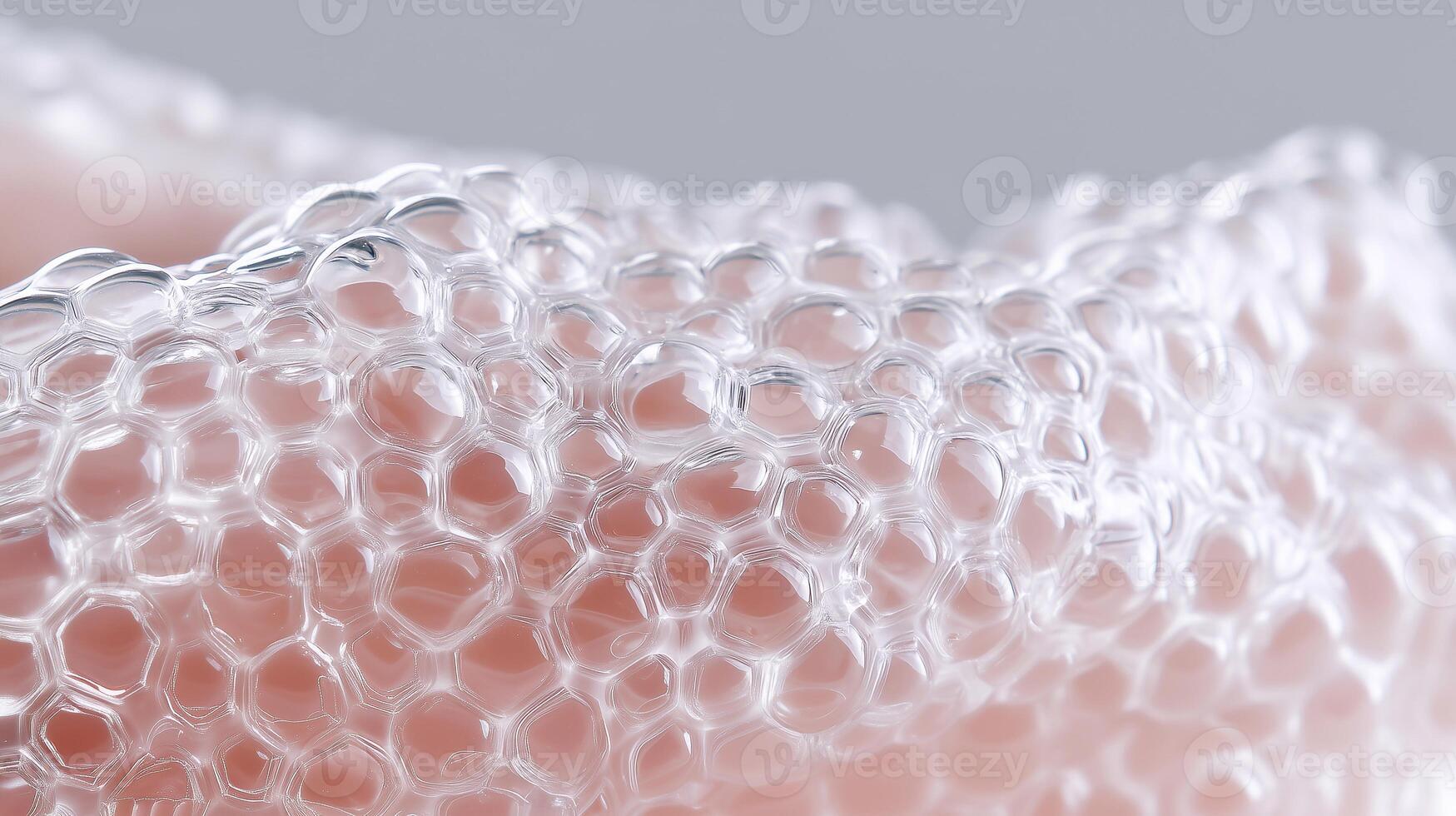 Macro view of transparent synthetic skin material with honeycomb texture, representing innovative biomedical engineering and advanced tissue design for human transplantation and wound healing. photo