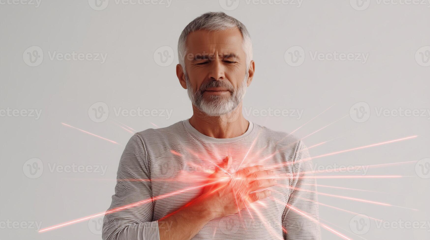 Senior man suffering chest pain with glowing red heart area symbolizing heart attack, hypertension or cardiac disease. Conceptual image for medical, health and cardiology themes. photo