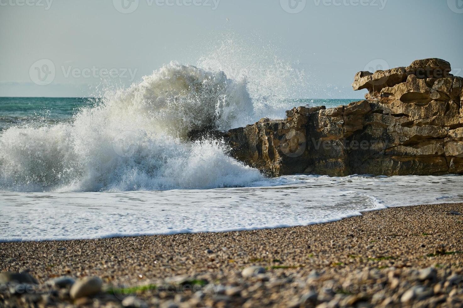 Powerful Ocean Waves Crashing Against Rocky Coastline in Natural Scene photo