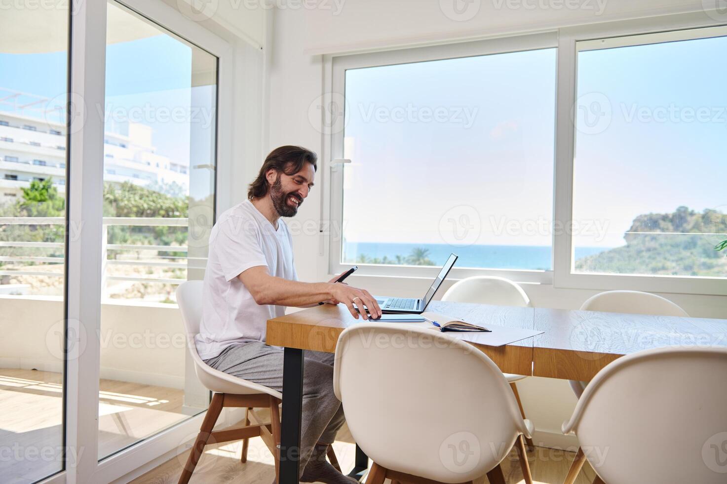Man Working Remotely From Modern Home Office With Scenic View photo