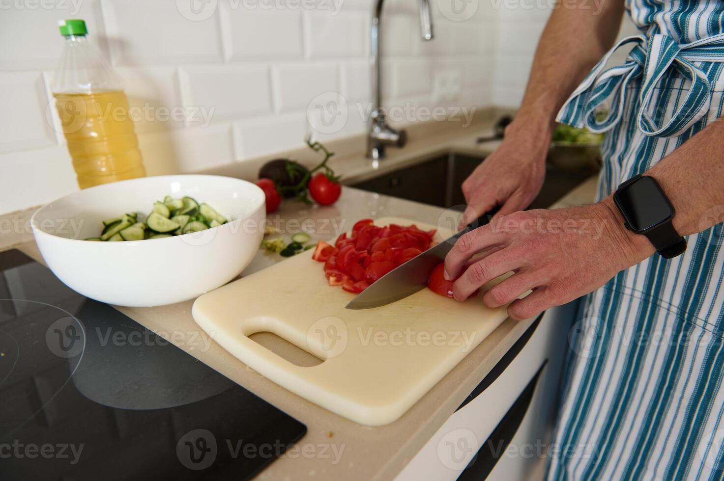 Man Preparing Fresh Salad in a Modern Home Kitchen Setting photo