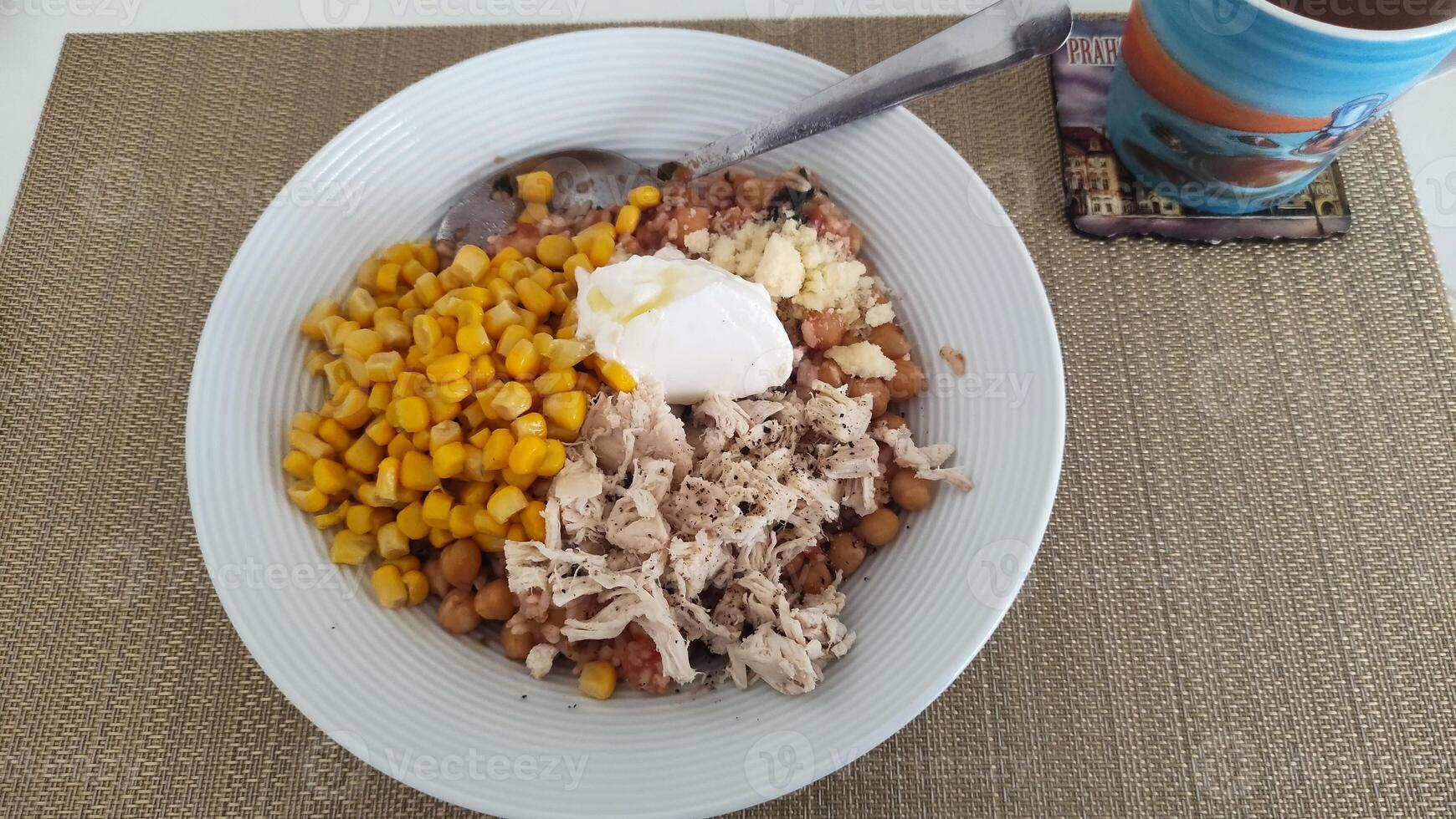 Healthy chicken chickpea corn and rice bowl with yogurt topping photo