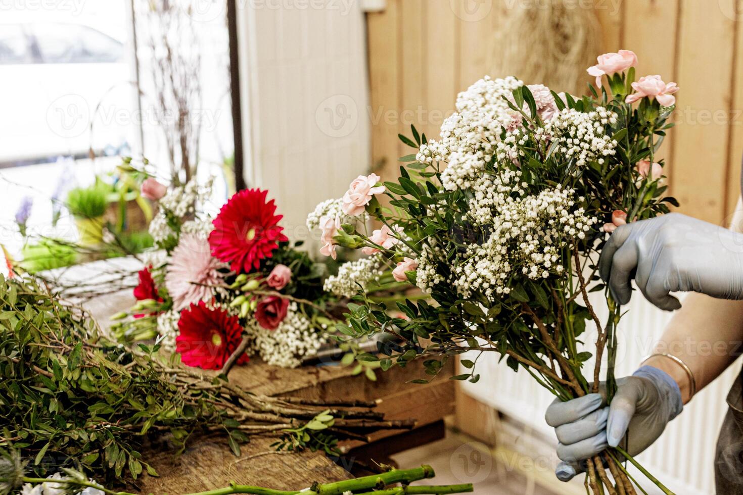 Florist arranging a bouquet of pink and white flowers in a flower shop, Mothers day photo