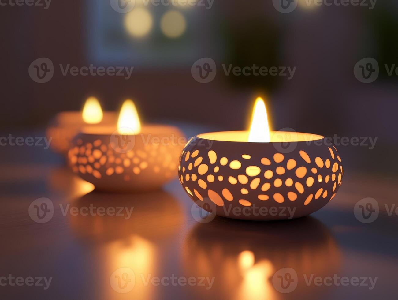 Illuminated Candles in Decorative Holders Resting on a Table photo
