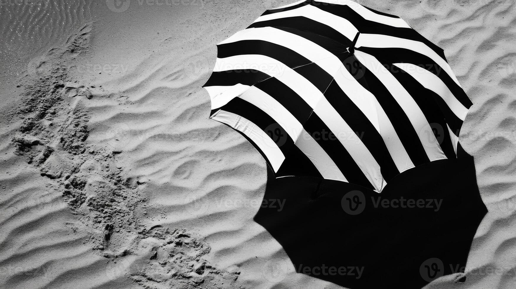 Black And White Striped Umbrella On Sandy Beach photo