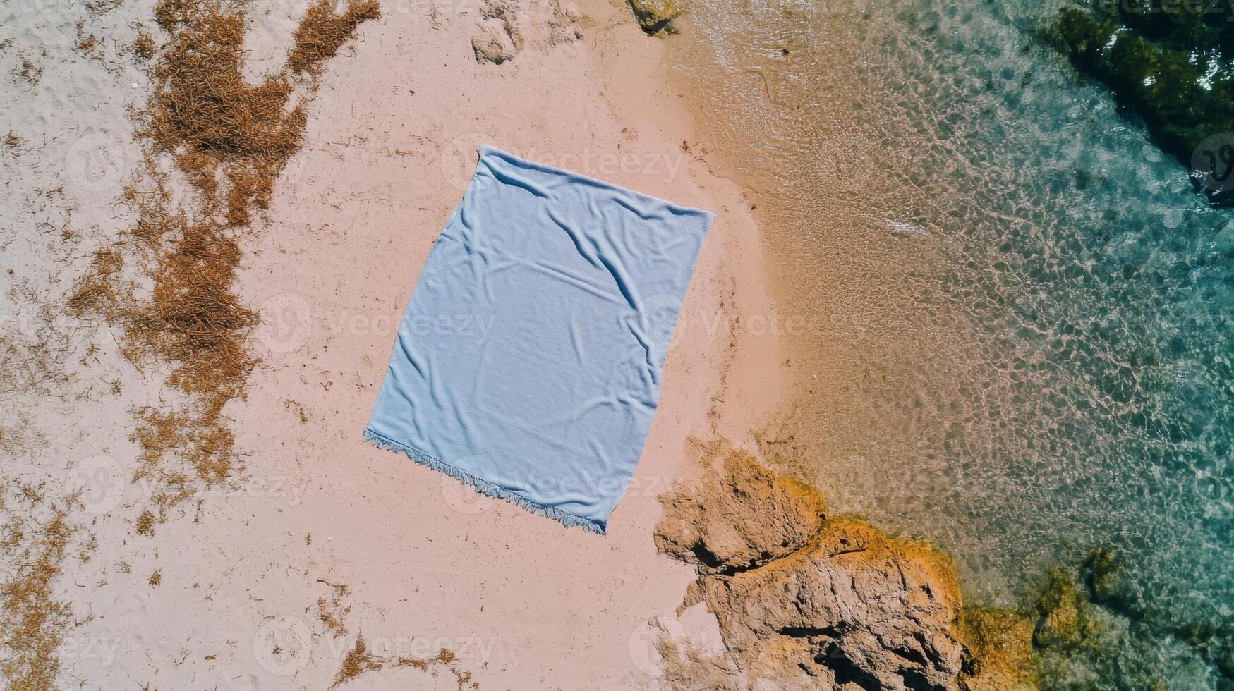 Blue Beach Towel on Sandy Shore Near Ocean Water photo