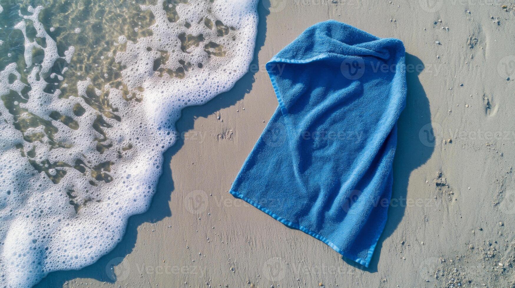 Blue Towel on Sandy Beach Near Ocean Wave photo