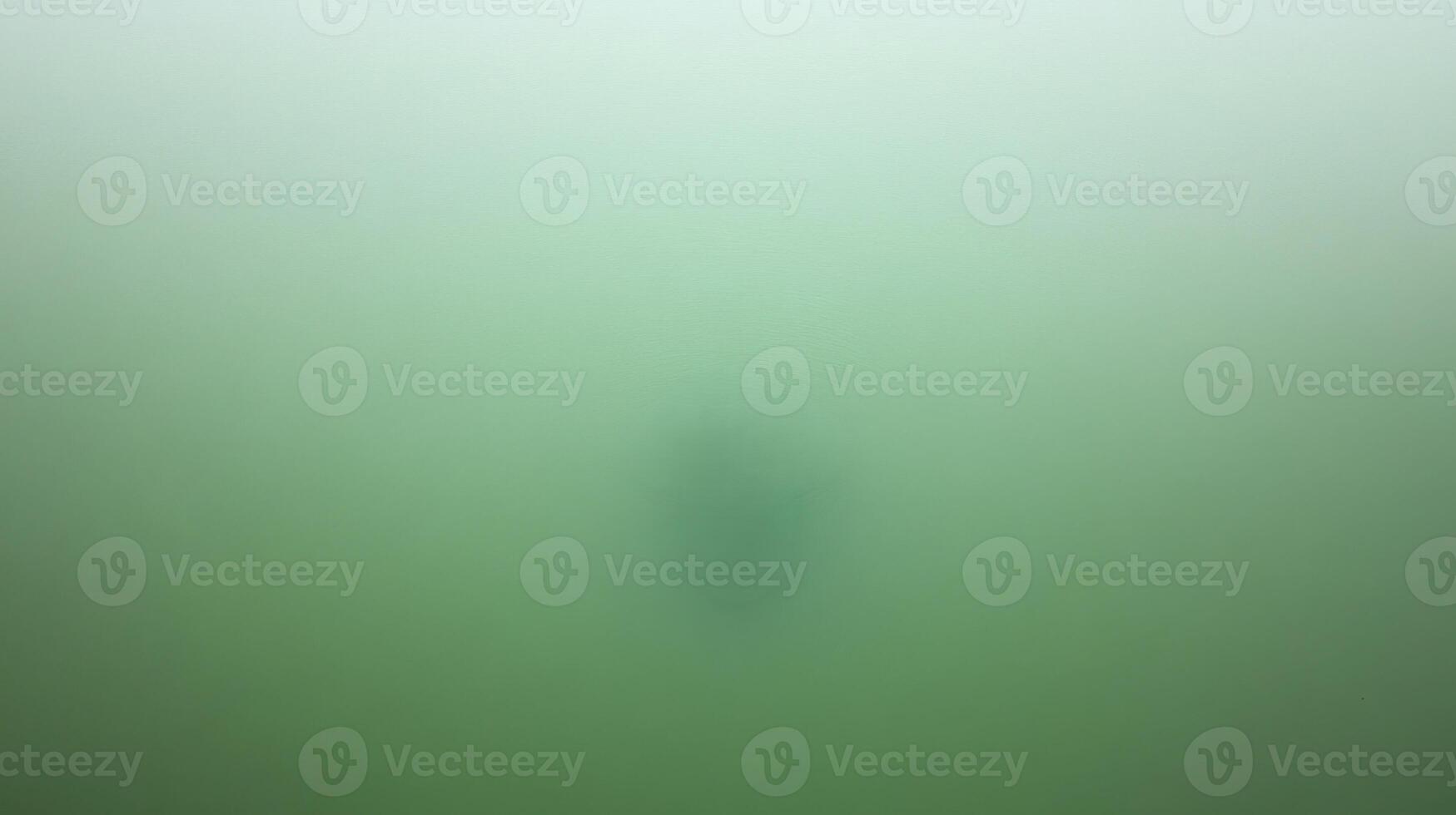 Solitary Figure Floating in Calm Green Water photo