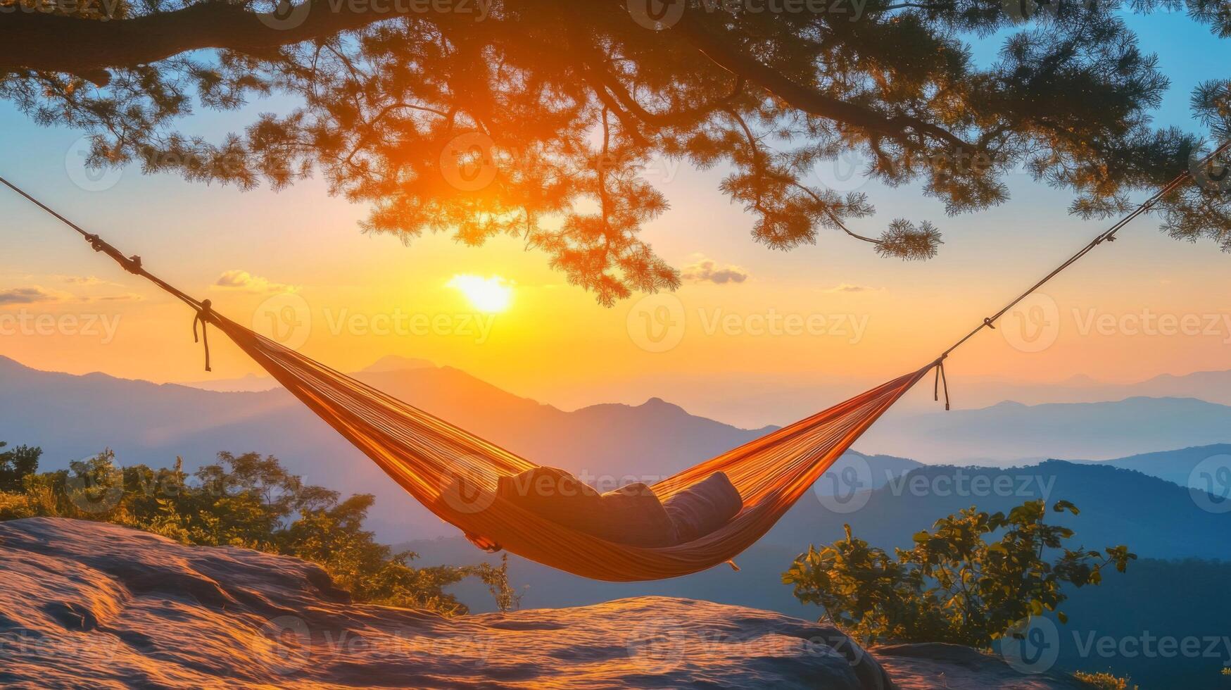 Relaxing in Hammock at Sunset Over Mountains photo