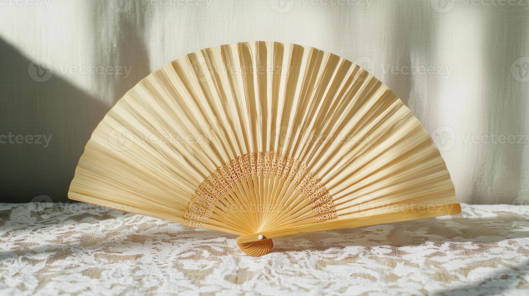 Beige Paper Hand Fan on Lacy Fabric photo
