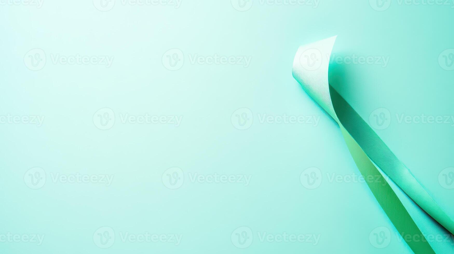 Ribbon curled on light turquoise background photo