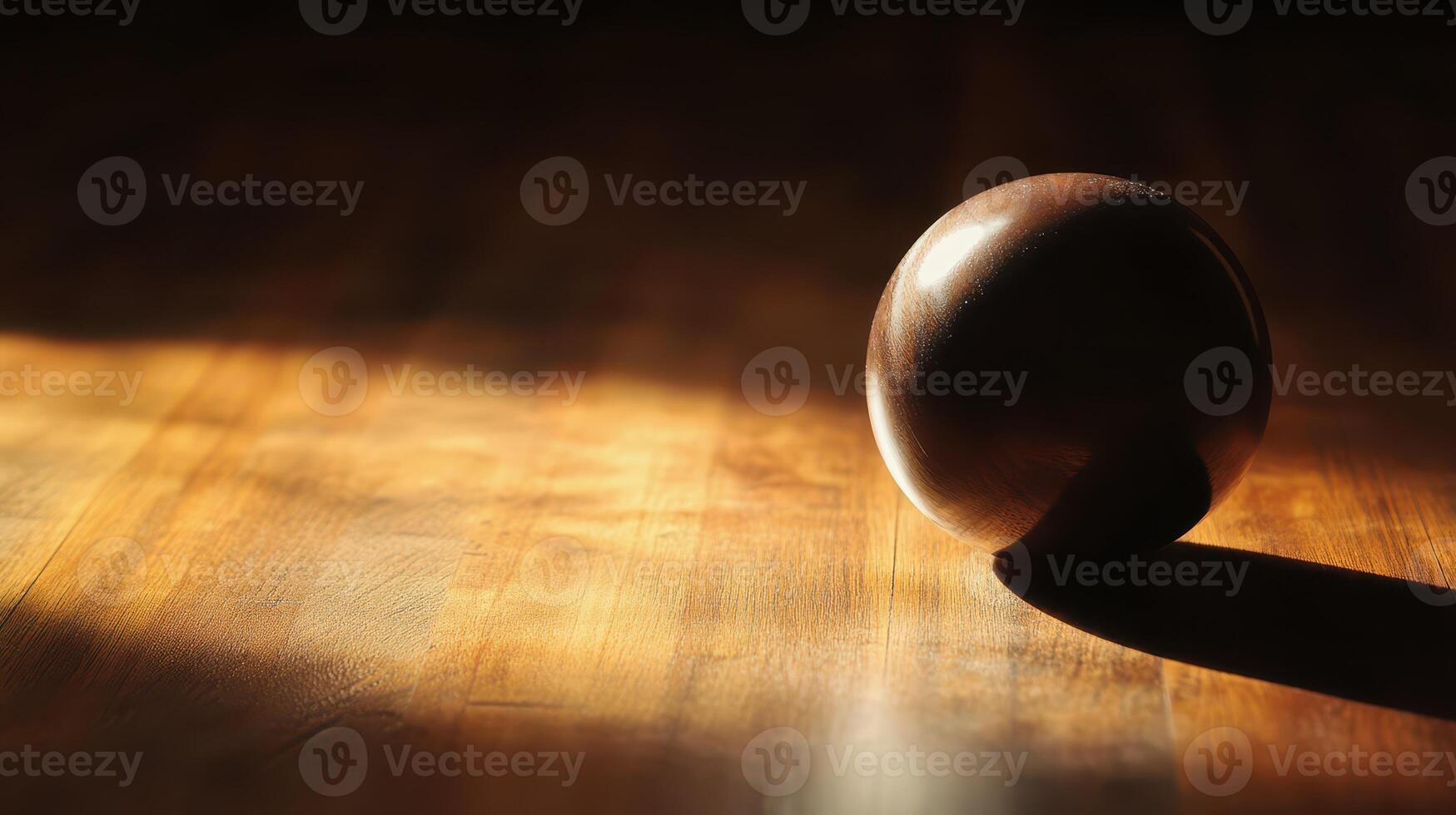 Brown sphere resting on a wooden surface photo