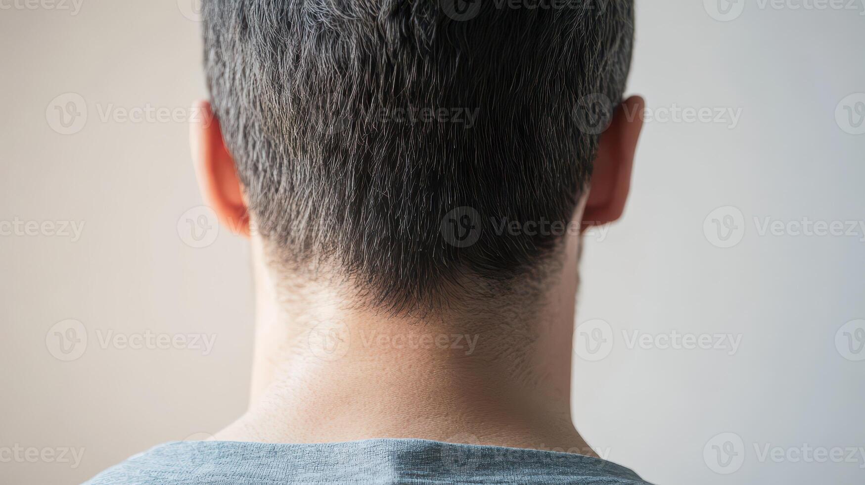 View of a mans back with short hair photo