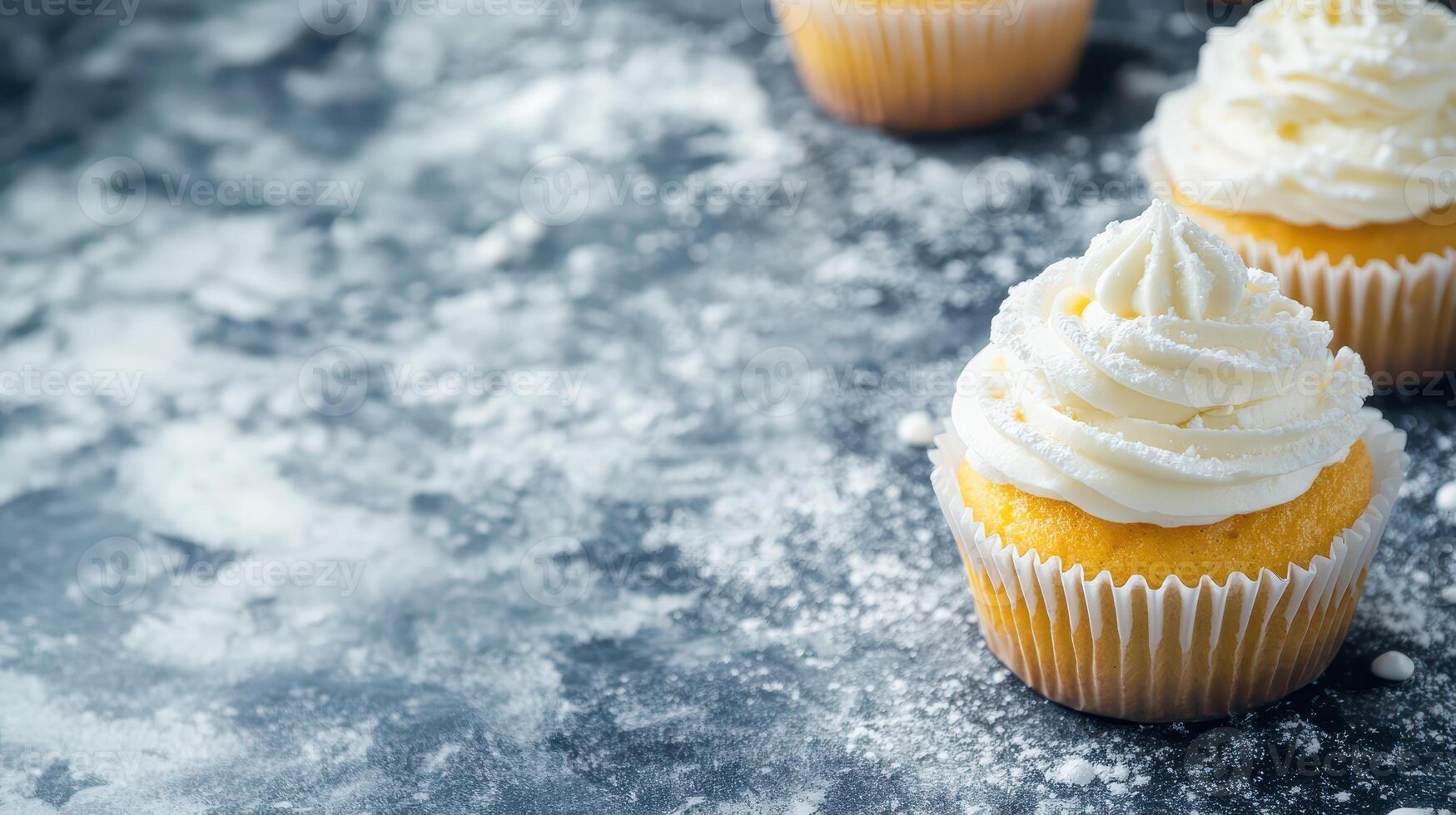 Delicious cupcakes topped with frosting on a table photo
