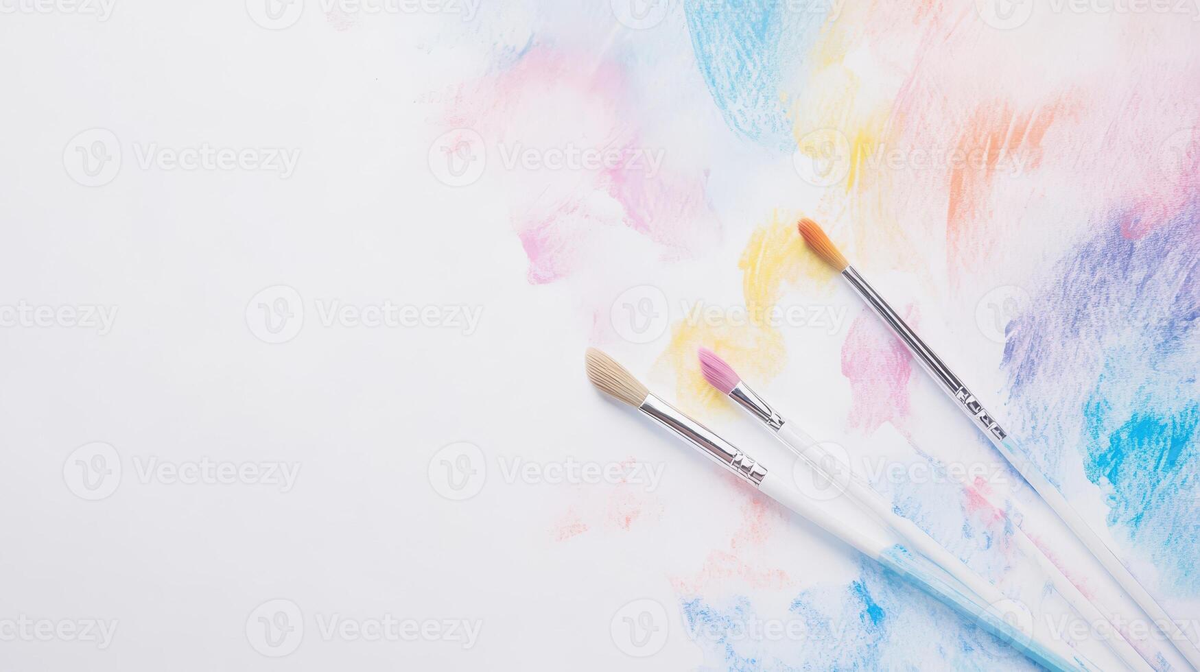 Colorful paint strokes with art brushes on canvas photo
