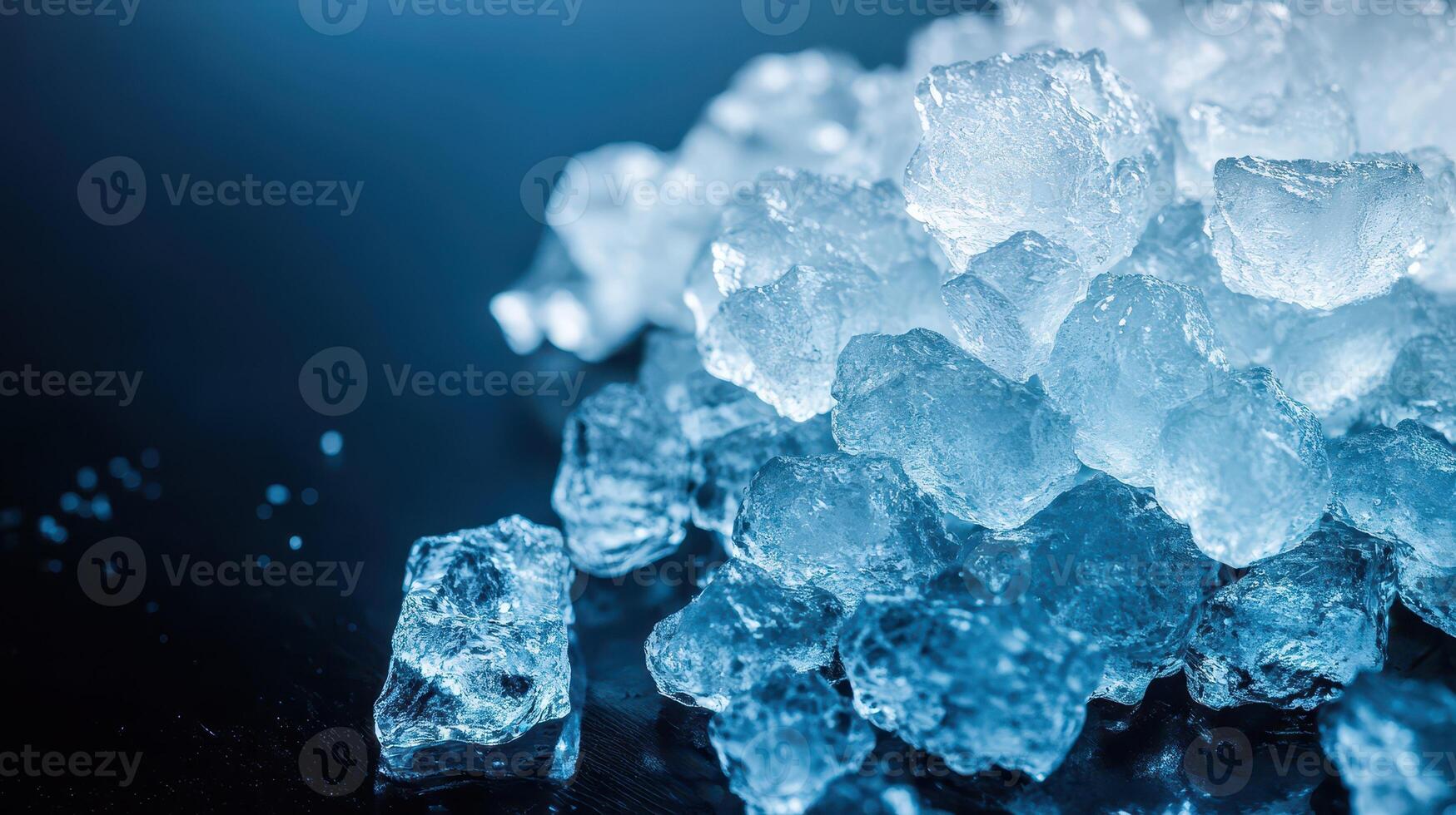 Ice cubes scattered on a dark surface photo