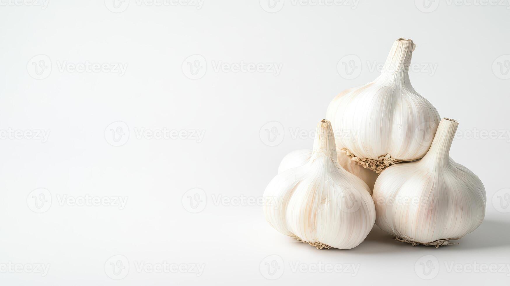 Garlic bulbs stacked on a clean surface photo