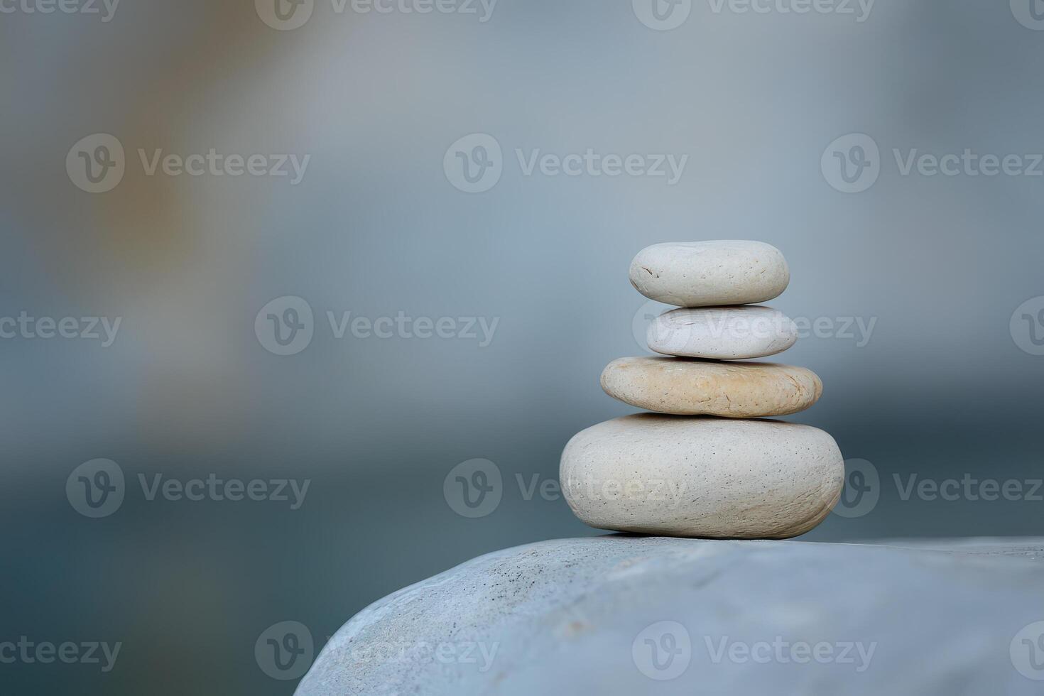 Natural stone stack on smooth surface by water photo