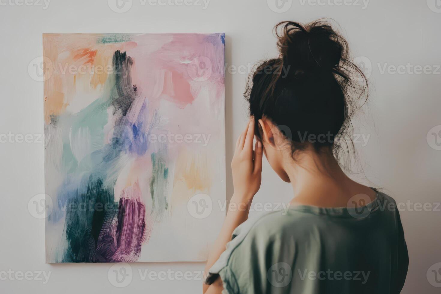 Woman observing abstract art in a modern setting photo