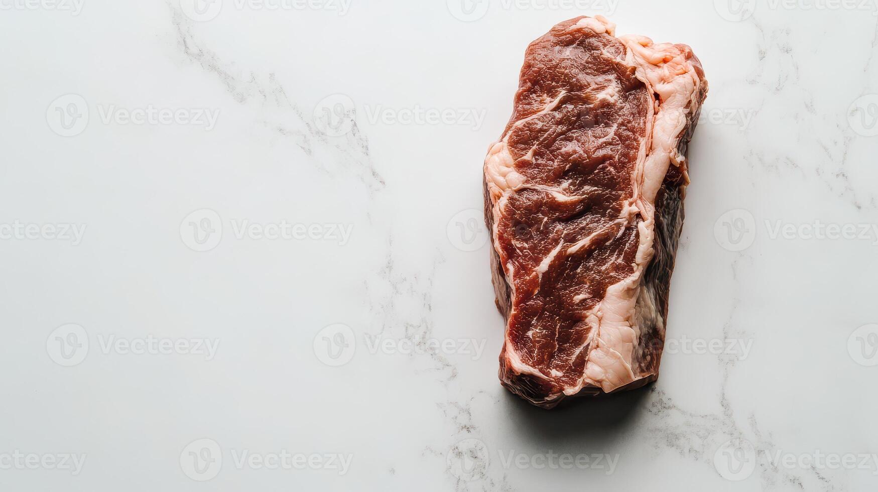 Fresh cut beef ribeye on a marble surface photo