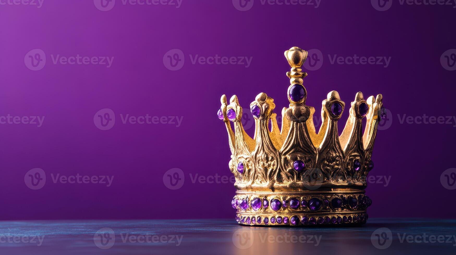 Golden crown adorned with purple jewels on a table photo