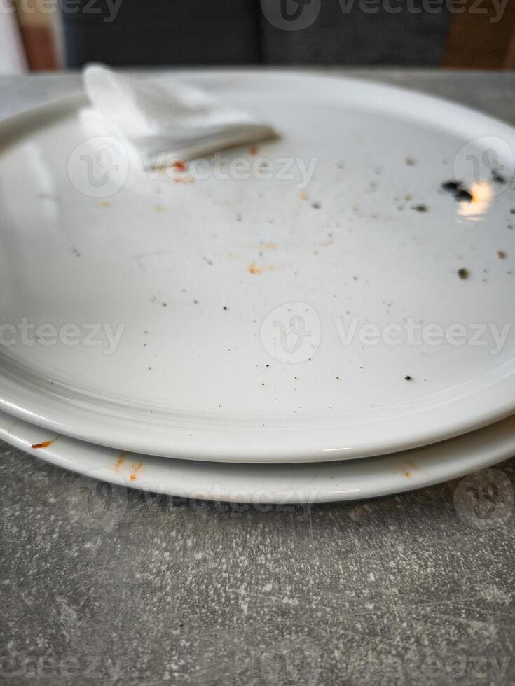 Empty plates with remnants of food and a napkin on a table showcasing the aftermath of a meal dining experience and food enjoyment concept photo