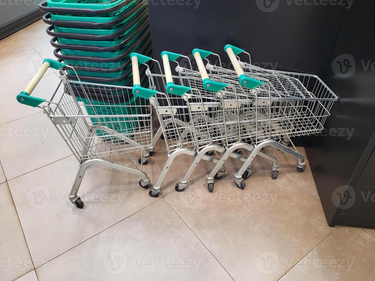 Small children's shopping carts are lined up. Equipment for transporting goods from markets, shopping malls and supermarkets. photo