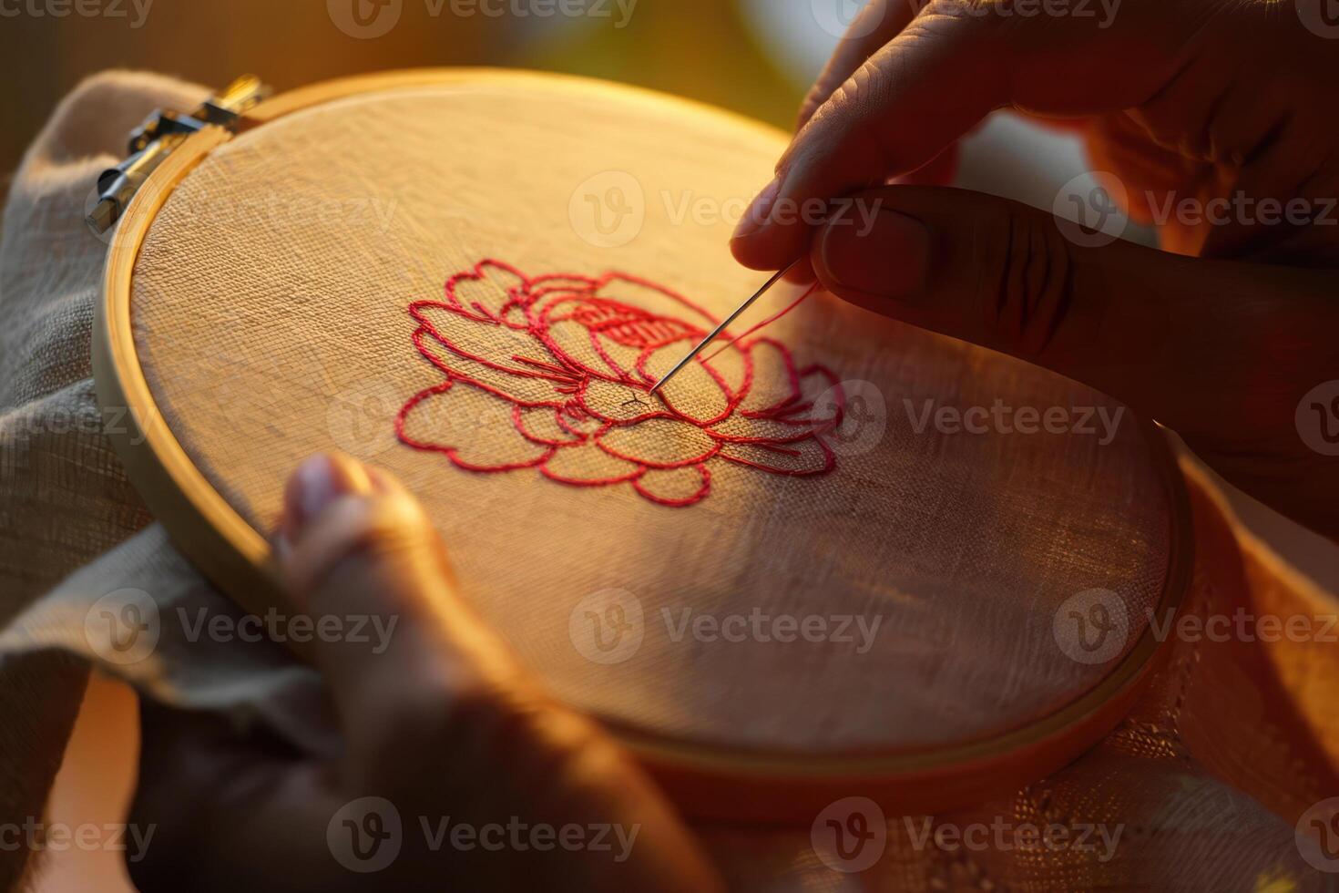 Crafting a detailed flower design with needle and thread in a warm light setting during the late afternoon hours photo