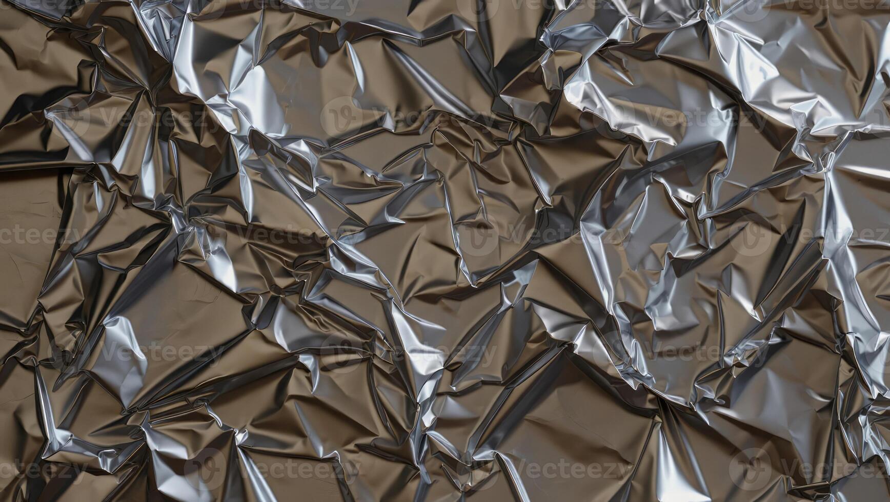Crumpled metallic foil creates an intriguing abstract texture showcasing reflections and shadows in a subtle, artistic display of light and form photo