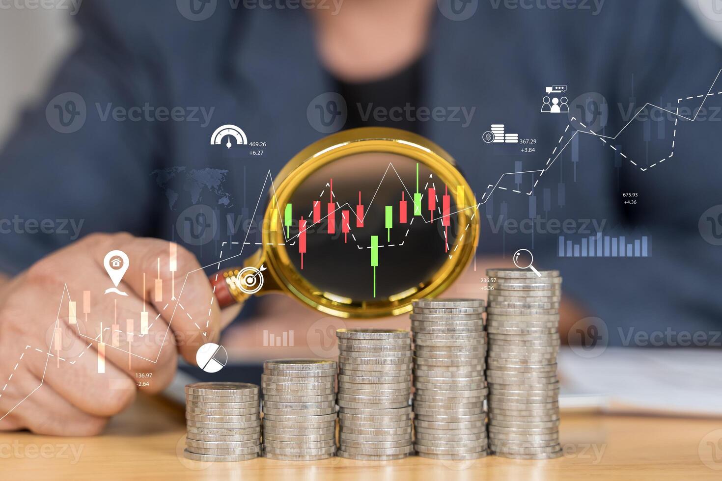 Stack of money coin and magnifying glass with graph and candle stick chart. photo