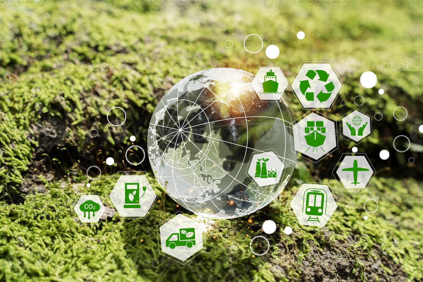 Sustainable transport and energy icons around transparent globe on green moss, ESG and net zero concept art photo
