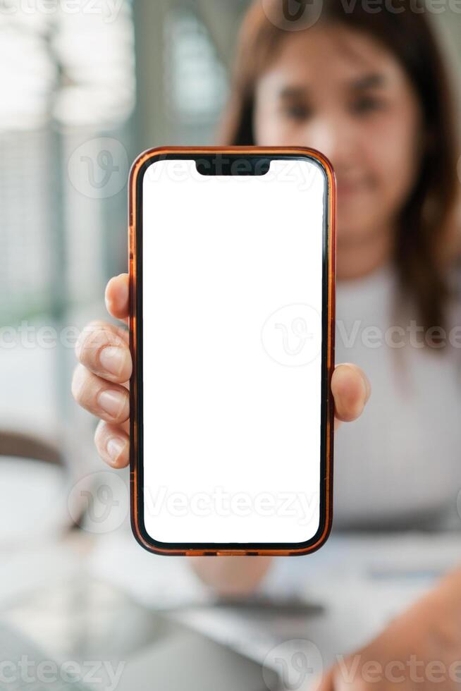 Close-up of a woman displaying a smartphone with a blank screen, ideal for app or website mockups. photo