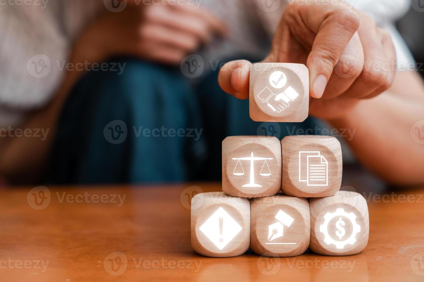 Wooden blocks with icons representing business contracts, legal agreements, and financial transactions in a professional setting. photo