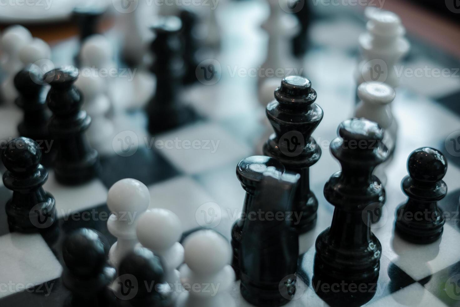 Detailed view of chess pieces on a board, showcasing strategy and competition in a classic game setting. photo