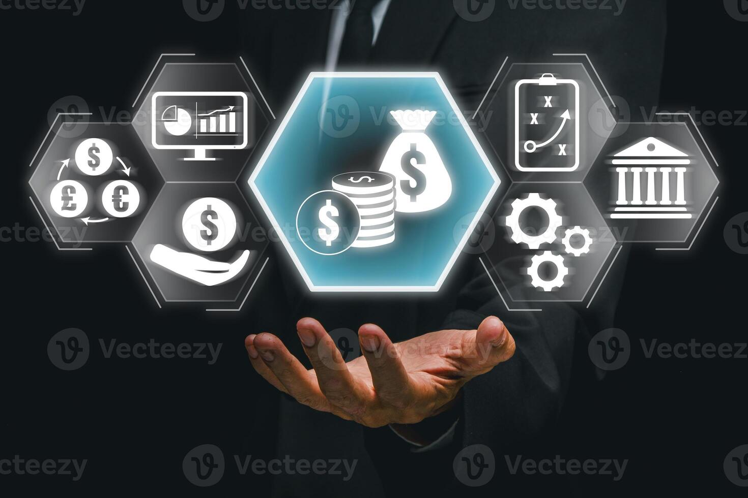 A businessman holds digital icons representing modern financial solutions, currency, and investment opportunities. photo
