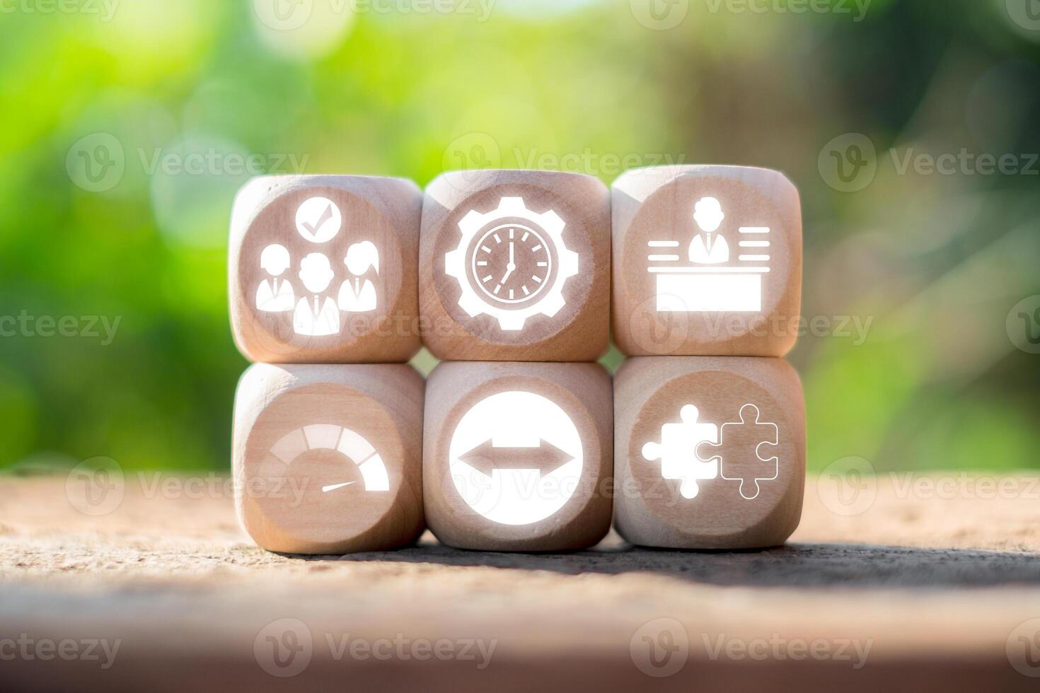 Wooden blocks with business icons representing the full-time equivalent concept in a natural outdoor setting. photo