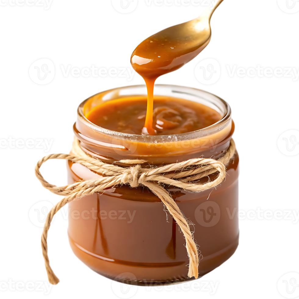 Delicious caramel sauce in a jar with a spoon png