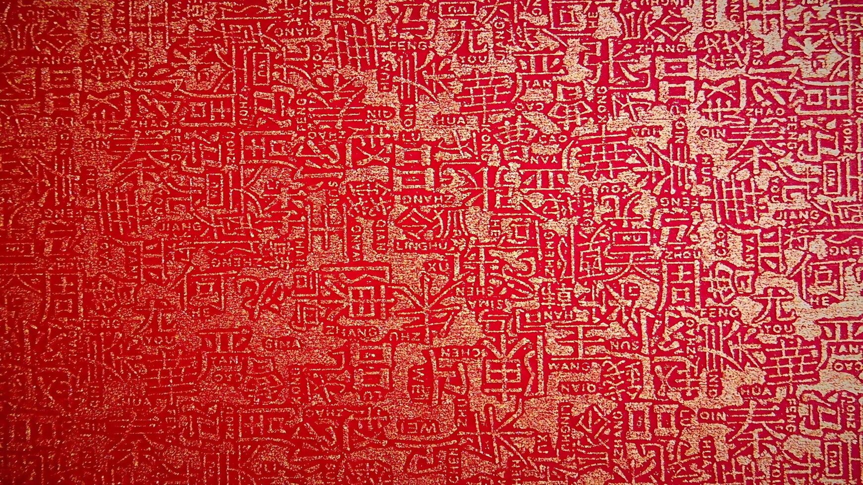 A red wall with many different designs on it photo
