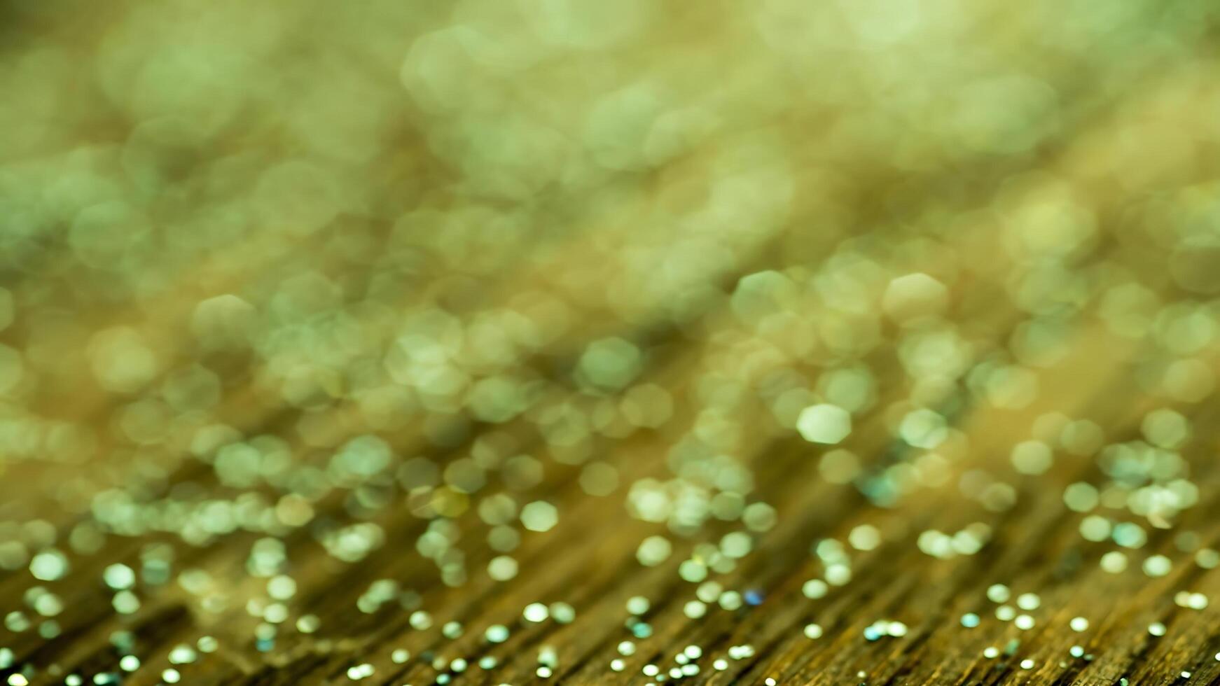 Golden sparkles on a green background photo