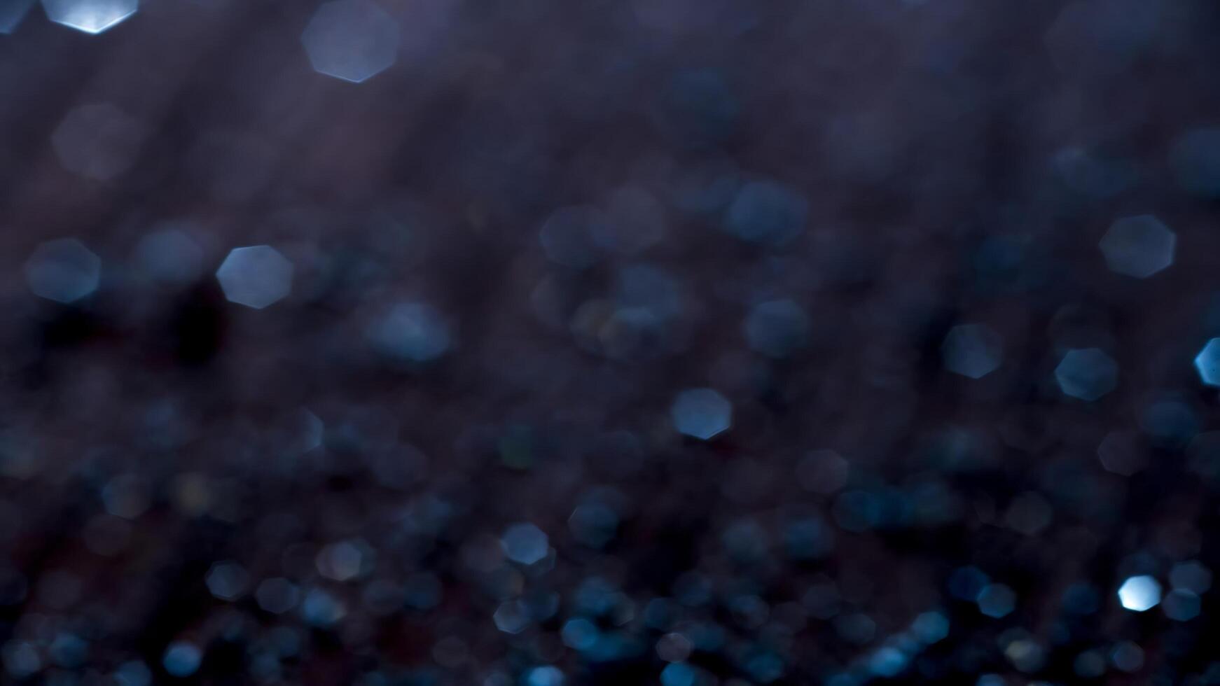 Raindrops on a dark background with a blurry image photo