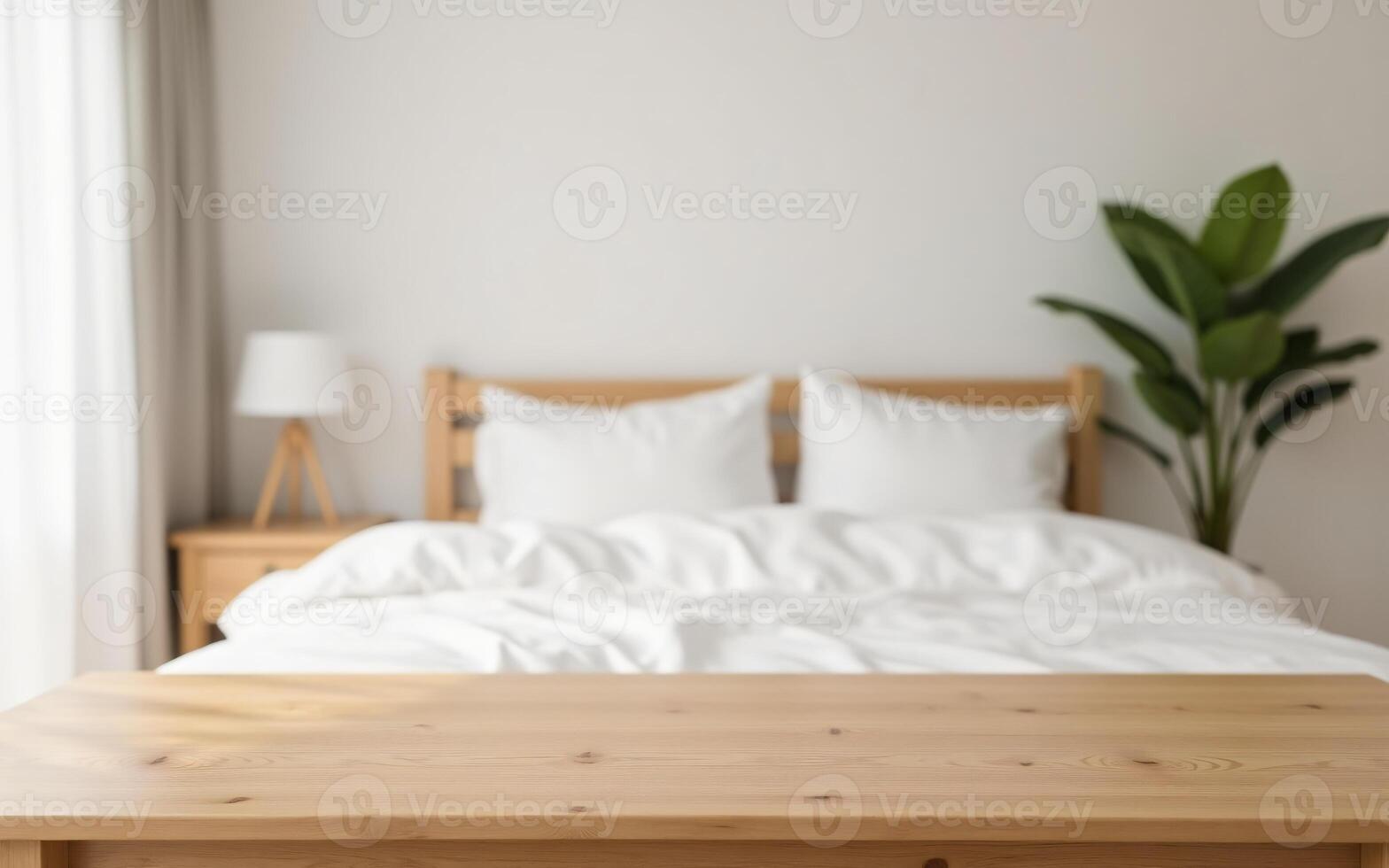 Empty light wood tabletop with strong blur of a cozy bedroom background featuring white sheets and soft lighting, Ready for products in the bedroom photo