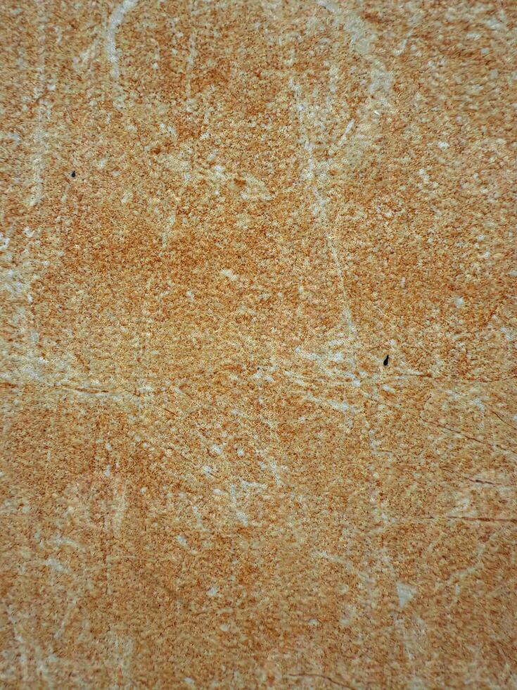 Textured Orange-Brown Surface with Scratches photo